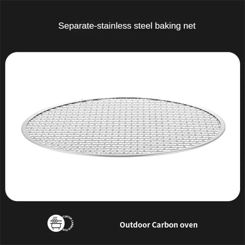 Portable stainless steel campfire grill with detachable parts and storage bag on grass
