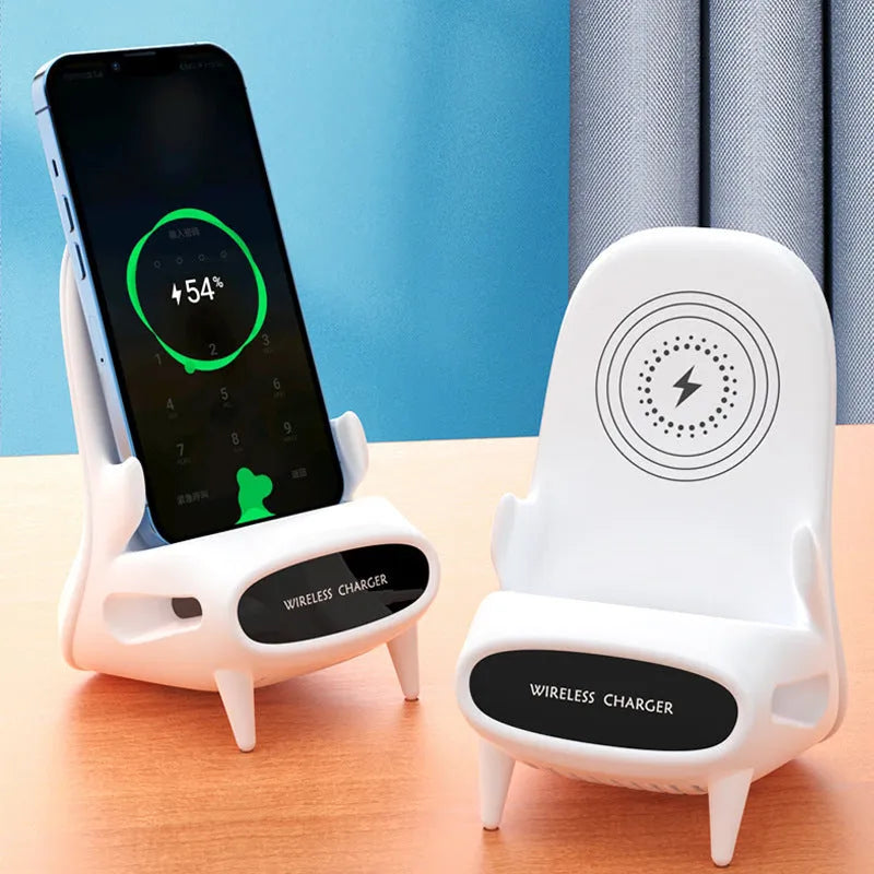 White chair-shaped wireless charging phone stand charging a smartphone on a desk