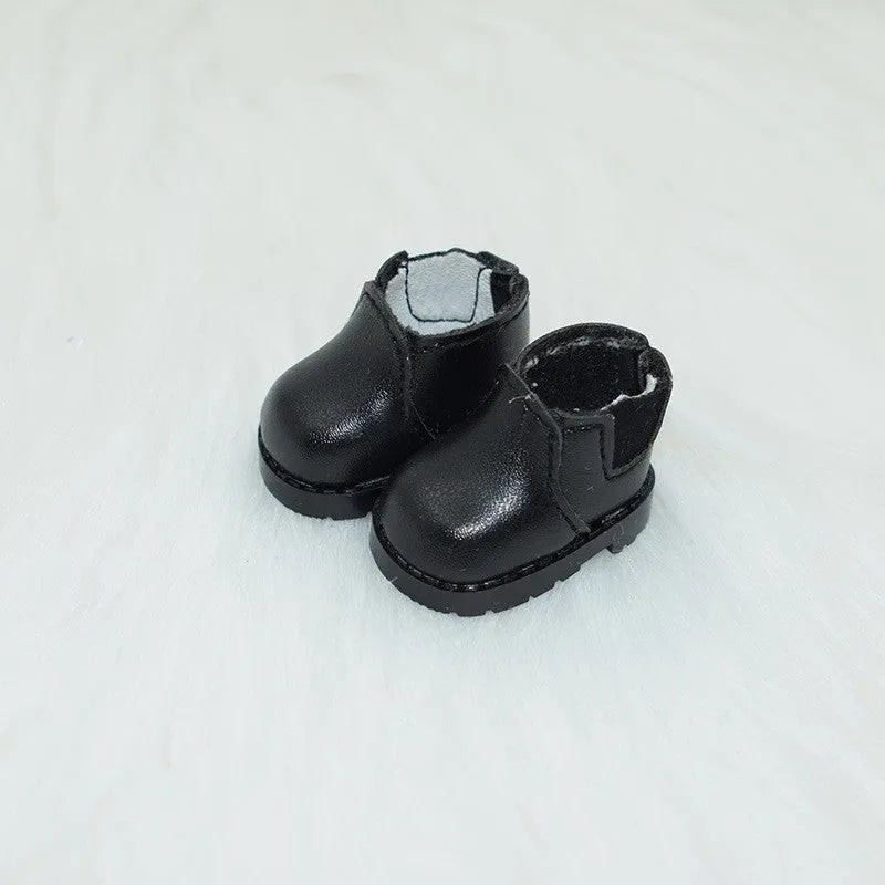 A pair of 17cm scale PU doll shoes in a selected colour and style, such as black leather shoes or brown boots.