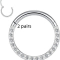 Close-up of a round, seamless stainless steel nose ring in a gold finish, showing its smooth, clasp-free design.