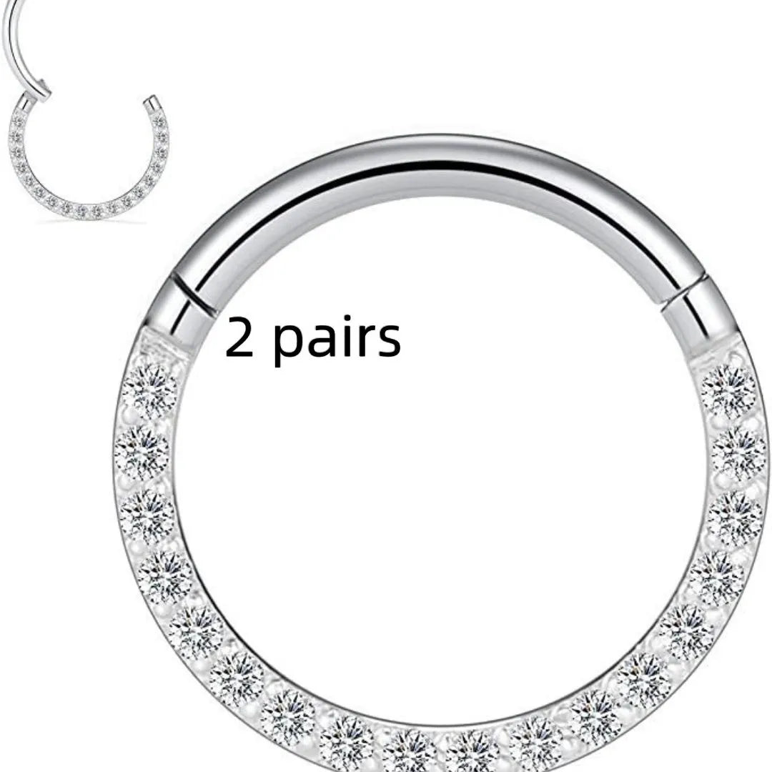 Close-up of a round, seamless stainless steel nose ring in a gold finish, showing its smooth, clasp-free design.