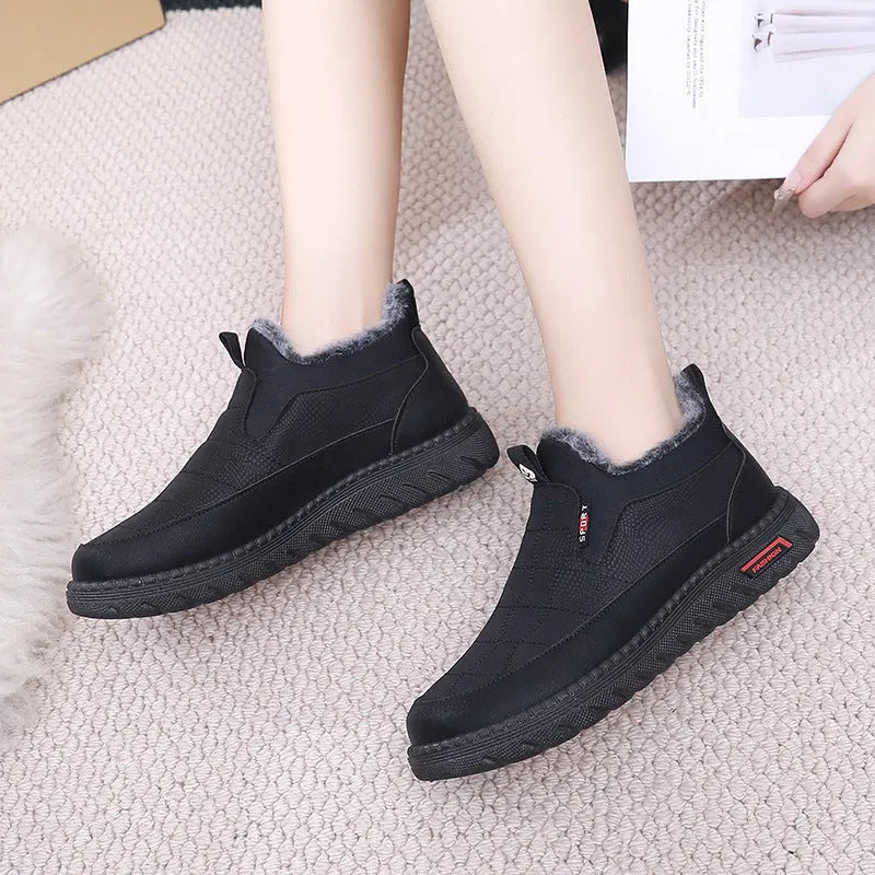 Women's black casual flat ankle boots with a round toe and non-slip rubber sole.