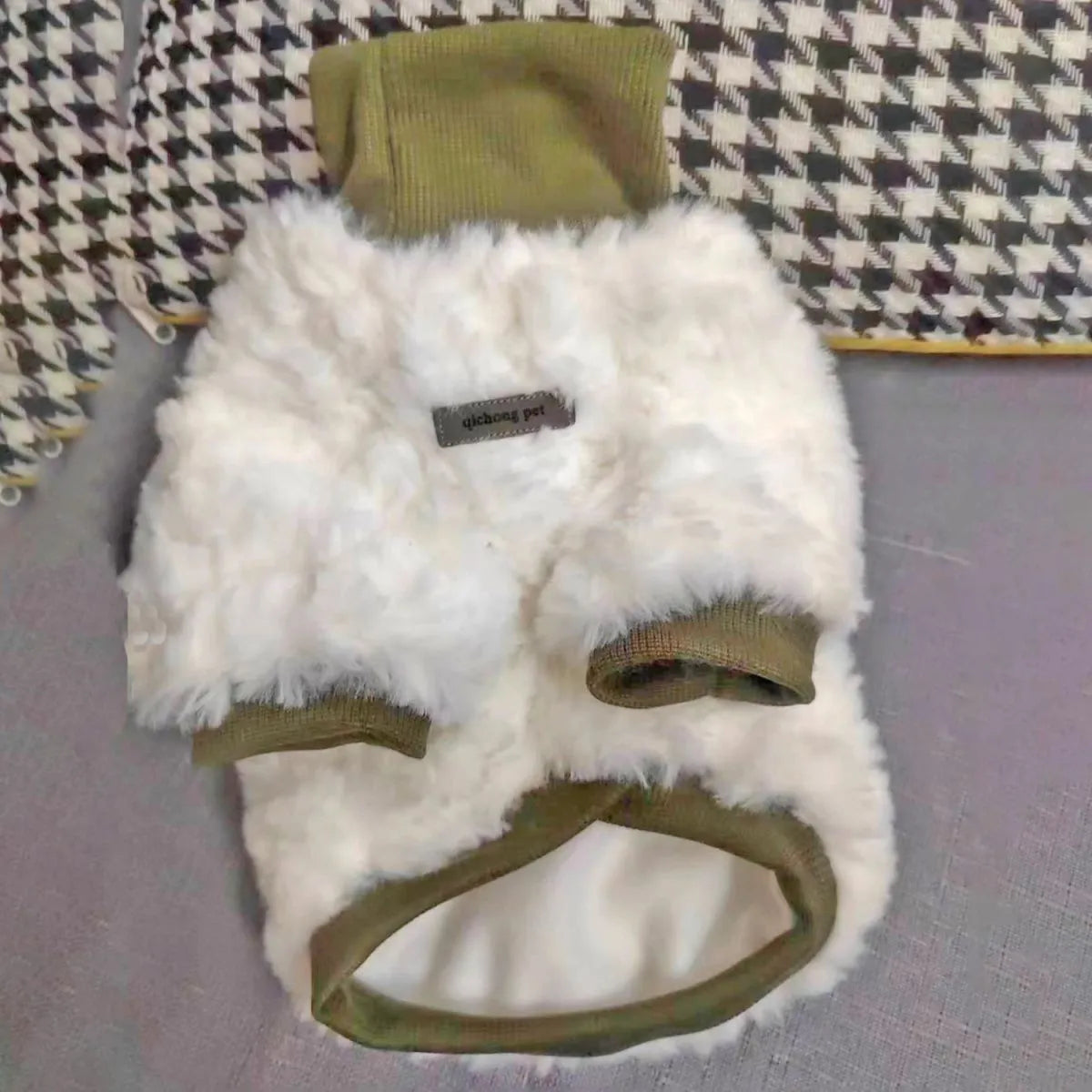 Small dog wearing thick turtleneck winter coat with plush padding in creamy green colour