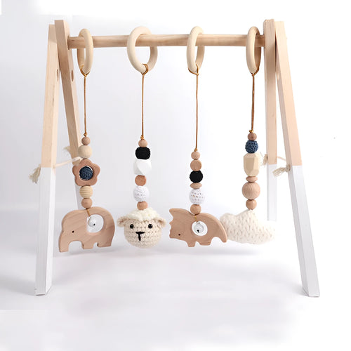 Beech wood baby rattle with animal pendants in orange, 28cm length, on white background