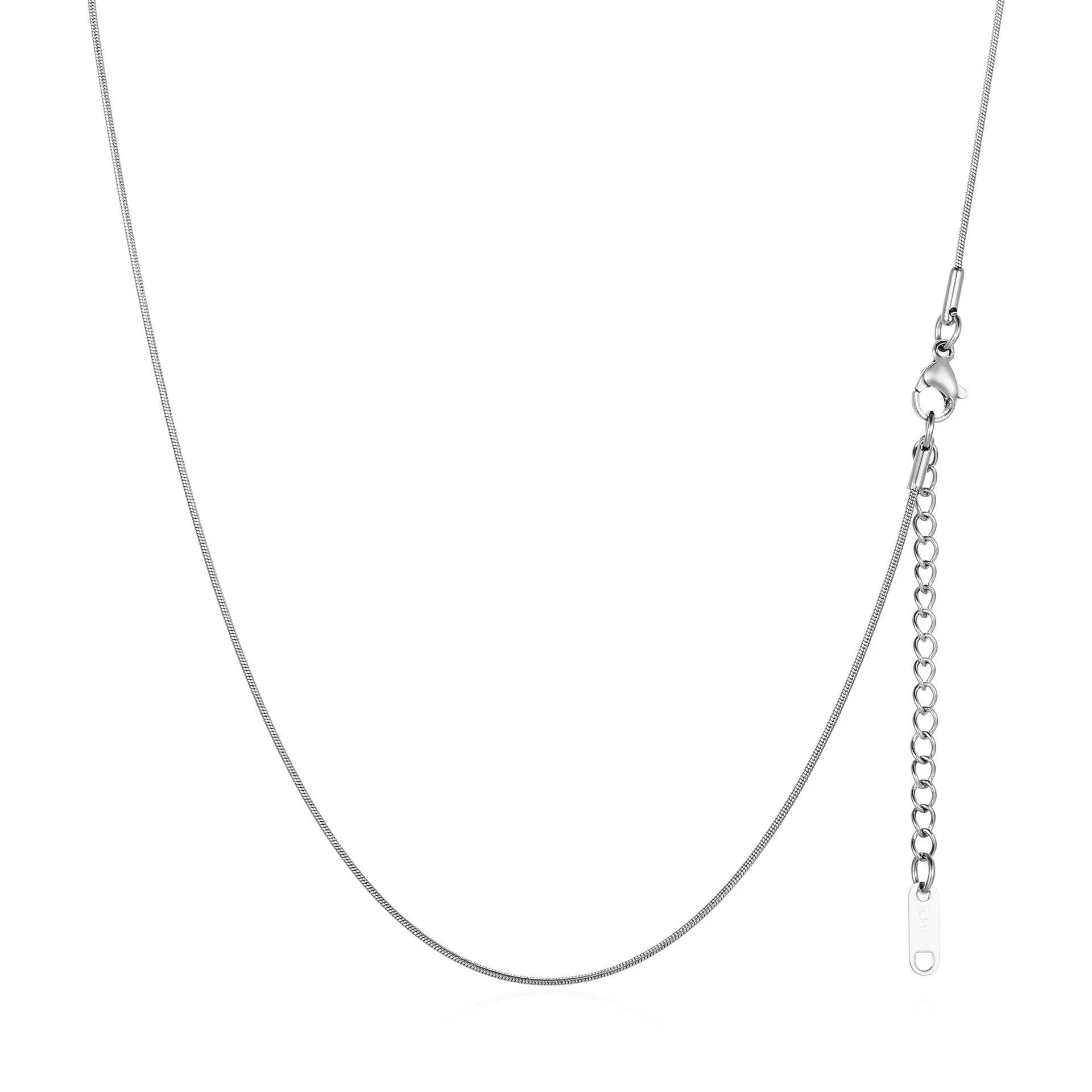 Women's stainless steel necklace with 18K gold hollow round pendant and O-link chain on neutral background