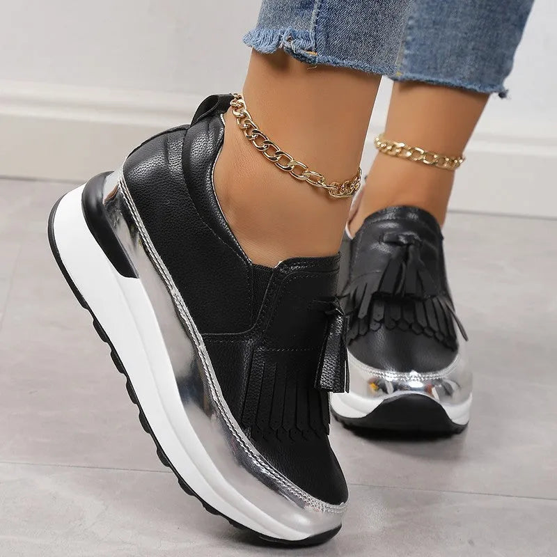 Women's black platform casual shoes with a tassel and a thick wedge heel.