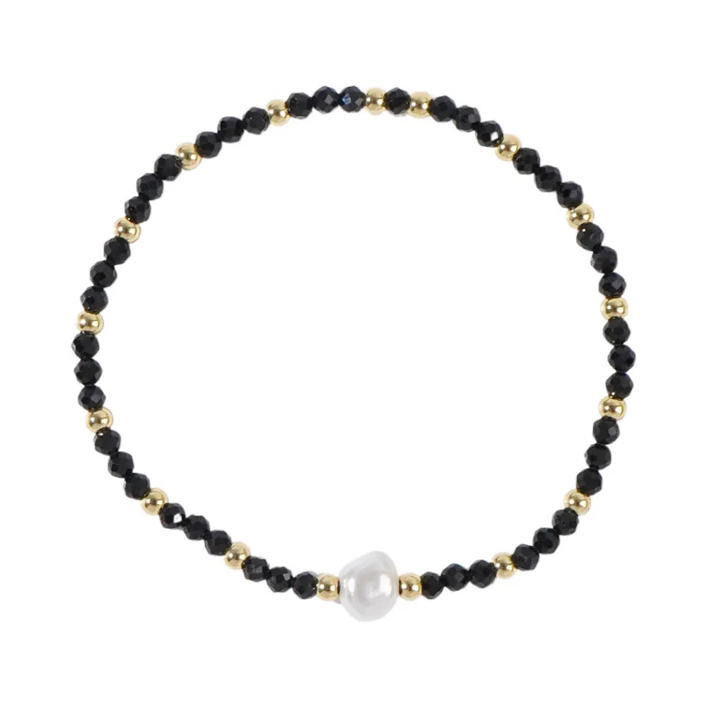 Close-up of a unisex natural stone bracelet with geometric ellipse beads on a wrist.