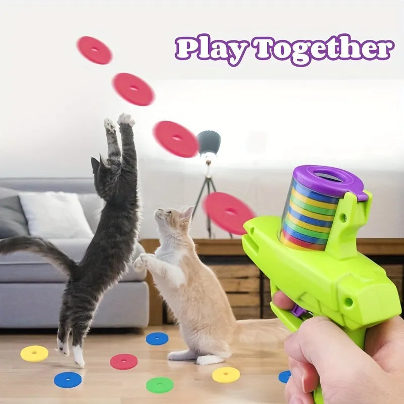 Green and purple manual cat toy launcher with foam discs for indoor pet play
