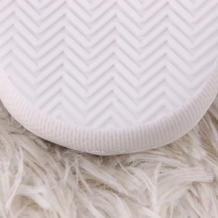White fluffy cartoon slippers with a non-slip rubber sole and toe holder design