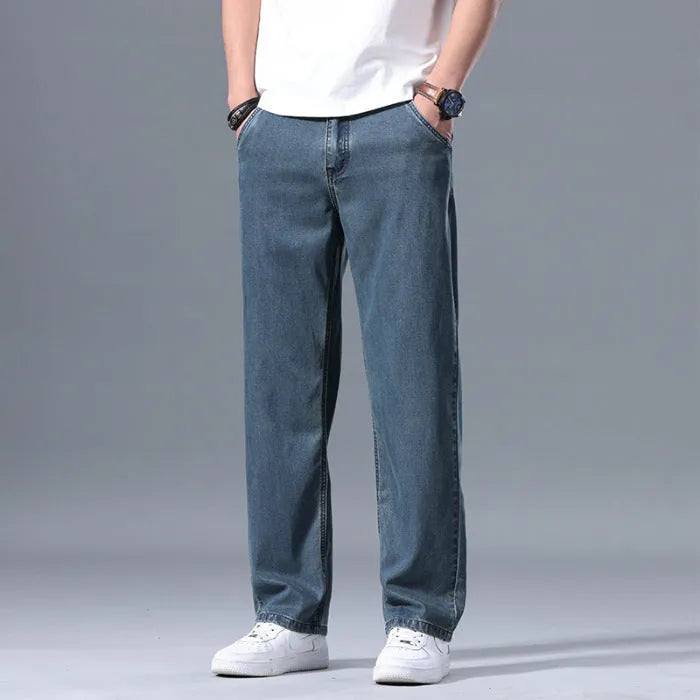 Man wearing light blue loose straight-leg lyocell jeans with a zipper fly.