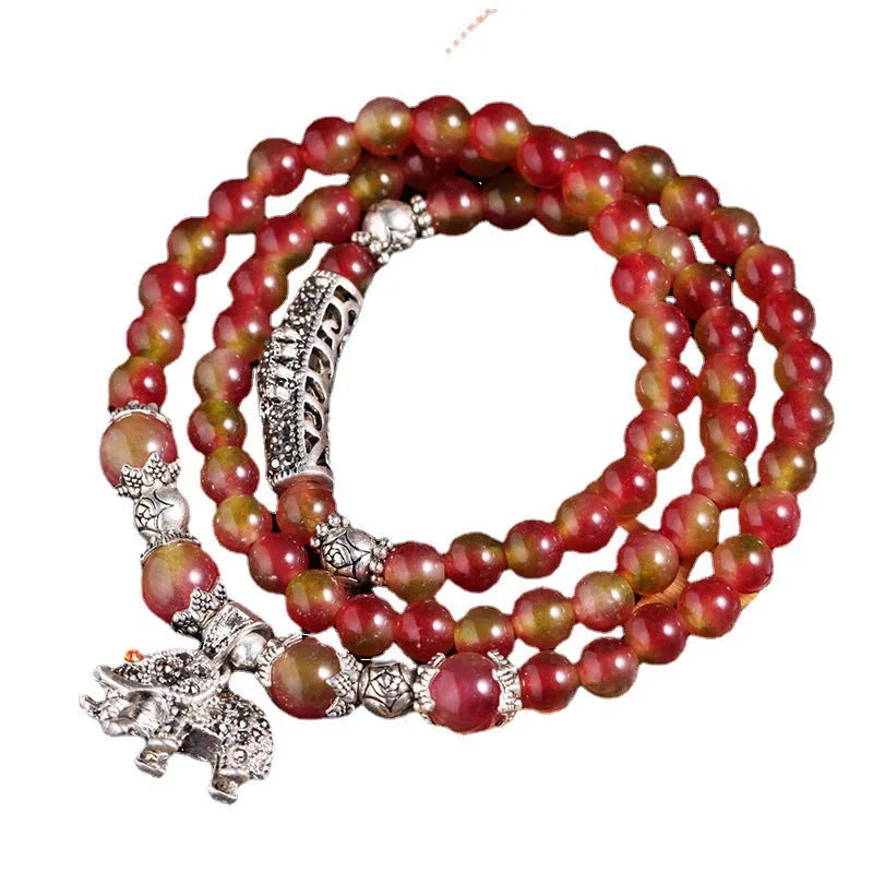 Watermelon crystal bracelet with Chinese knot closure and elephant bead design