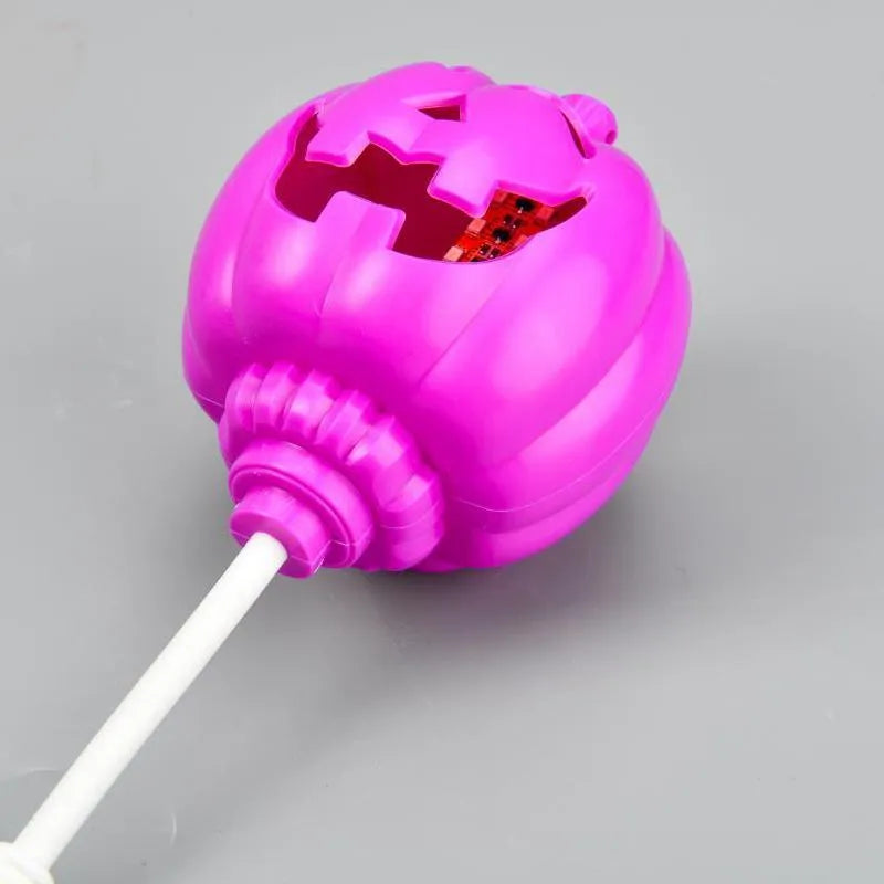 Plastic pumpkin-shaped lamp glowing with either purple or yellow light, measuring 22cm tall.