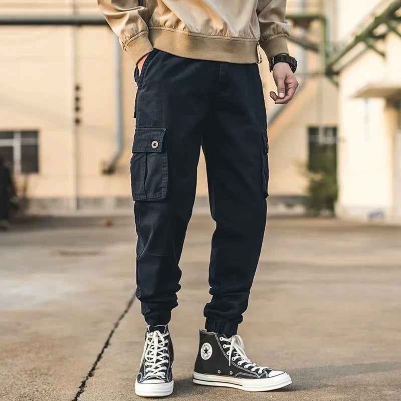Men's black cotton overalls with loose cropped fit, ankle banded hem, and multiple pockets