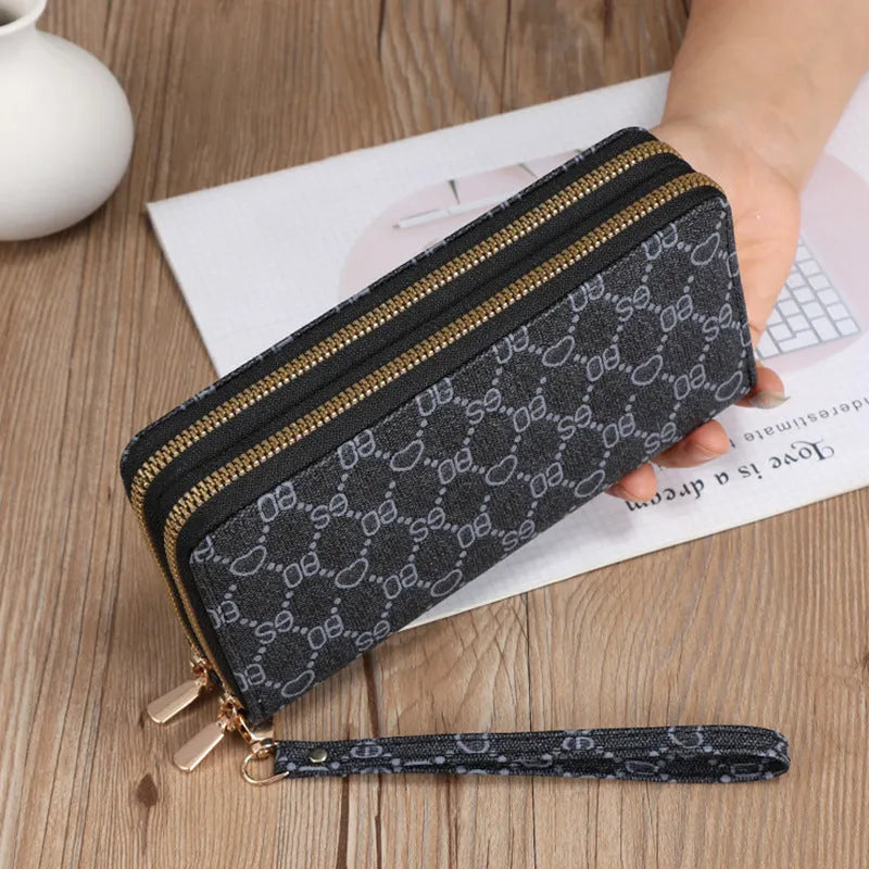 Long black PU leather wallet clutch with retro styling, open to show mobile phone compartment and coin purse sections