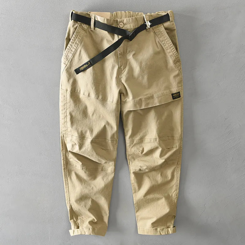 Man wearing khaki-coloured casual cotton overalls with a loose fit and mid-waist design.