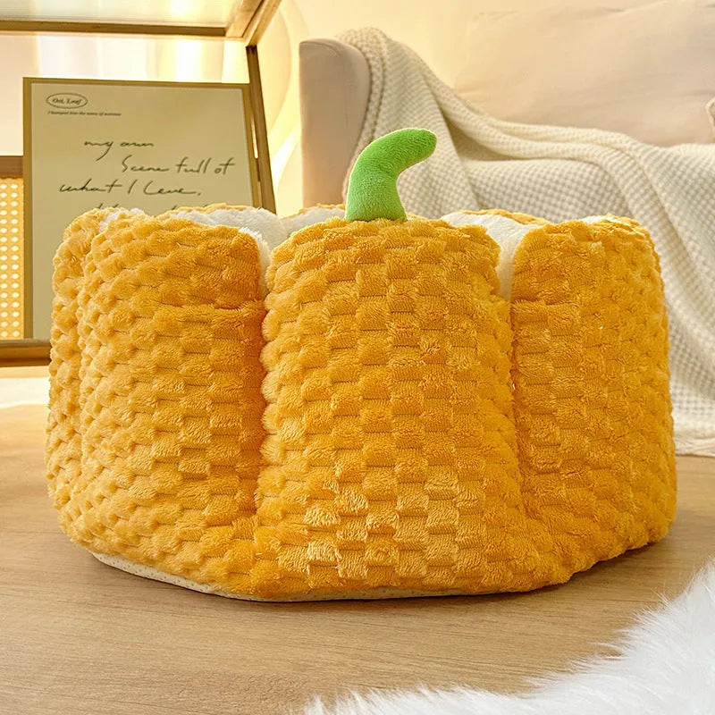 Orange pumpkin-shaped pet nest bed for cat or small dog with cotton filling.