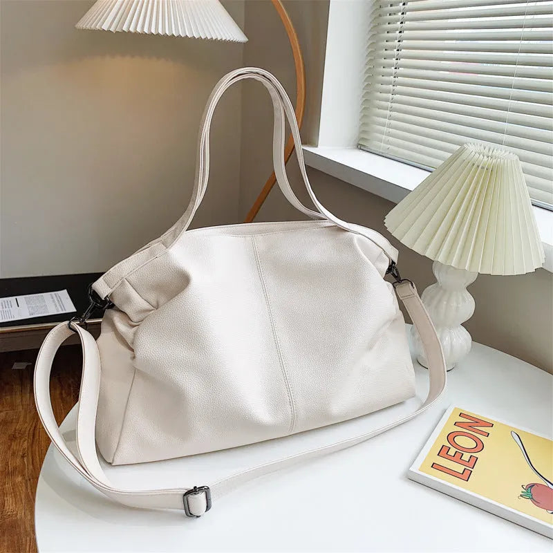Soft surface messenger shoulder bag in horizontal square shape with zipper opening and internal compartments