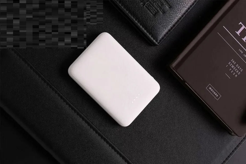 Portable mini 5000 mAh mobile power supply in black with multi USB port output