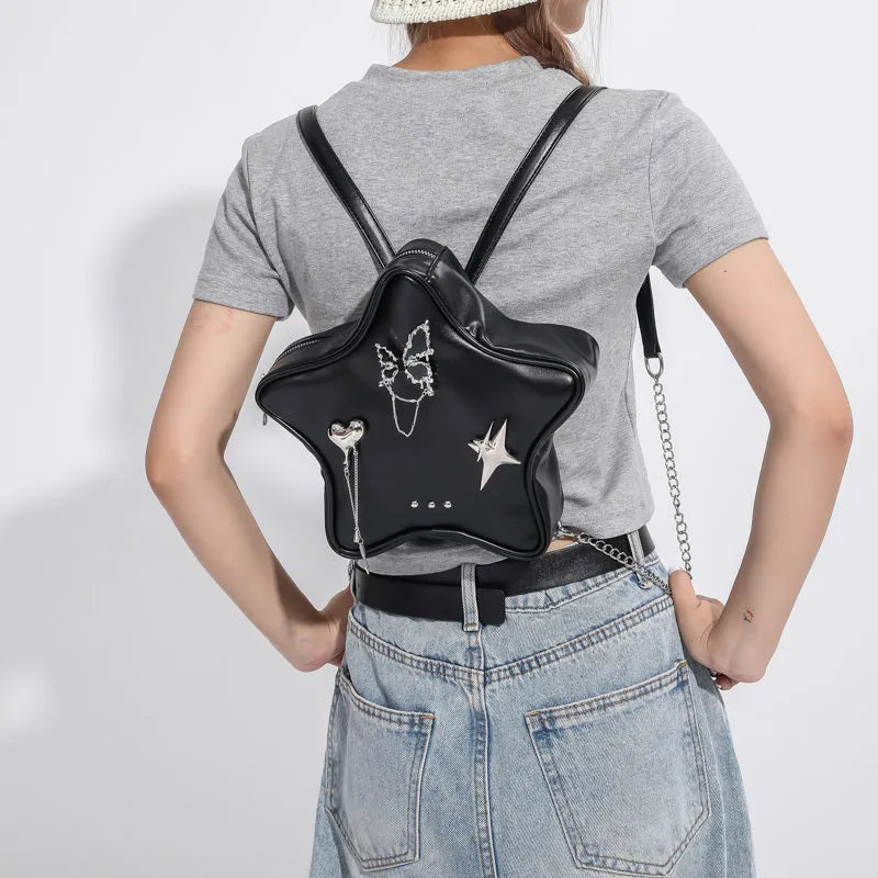 Women's soft black PU leather mini messenger backpack worn crossbody.