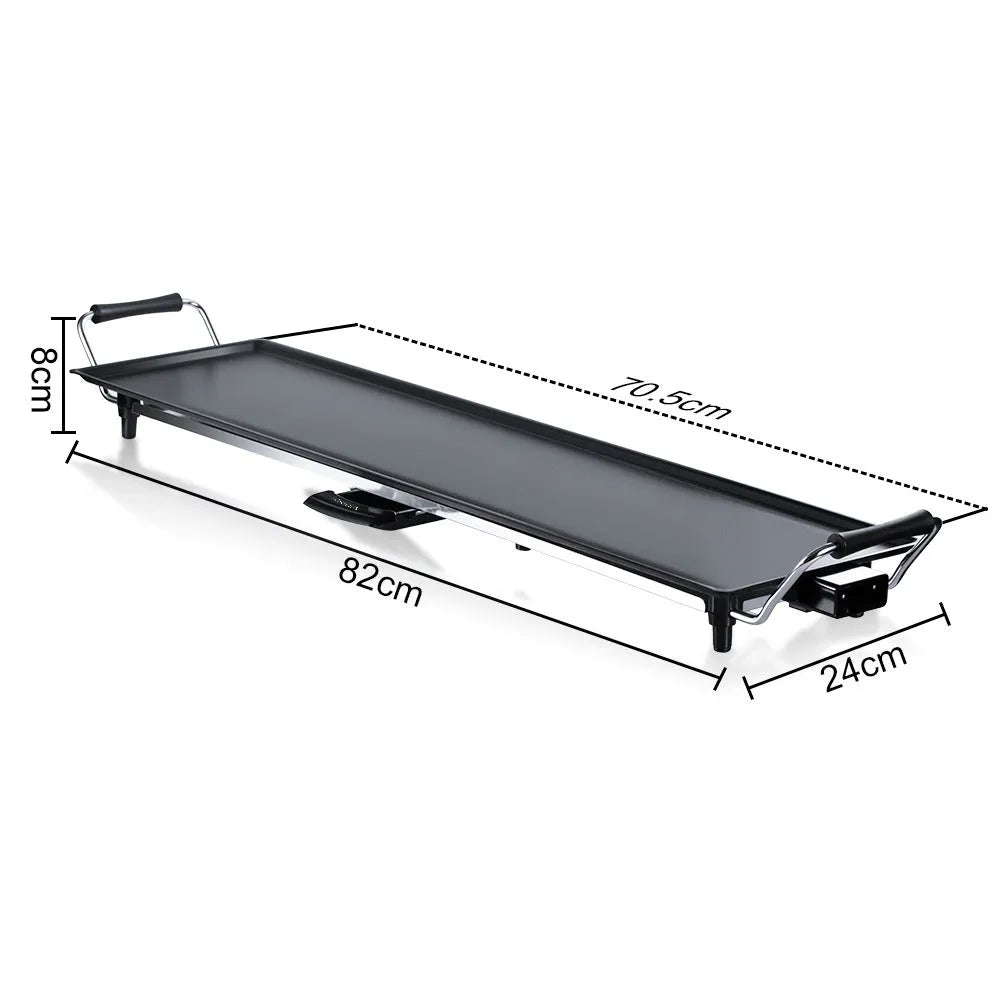 Square home multi-function electric grill pan with non-stick coating and iron body on kitchen countertop