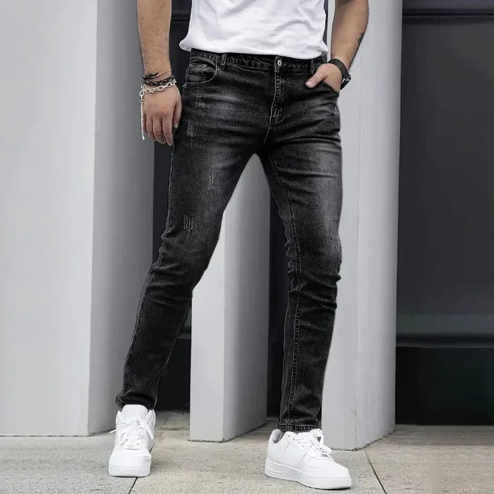 Men's straight leg jeans in stretch cotton denim showing high elasticity fabric and slim silhouette