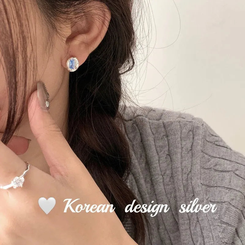 S925 sterling silver oval earrings with blue diamond heart-wrapped geometric design