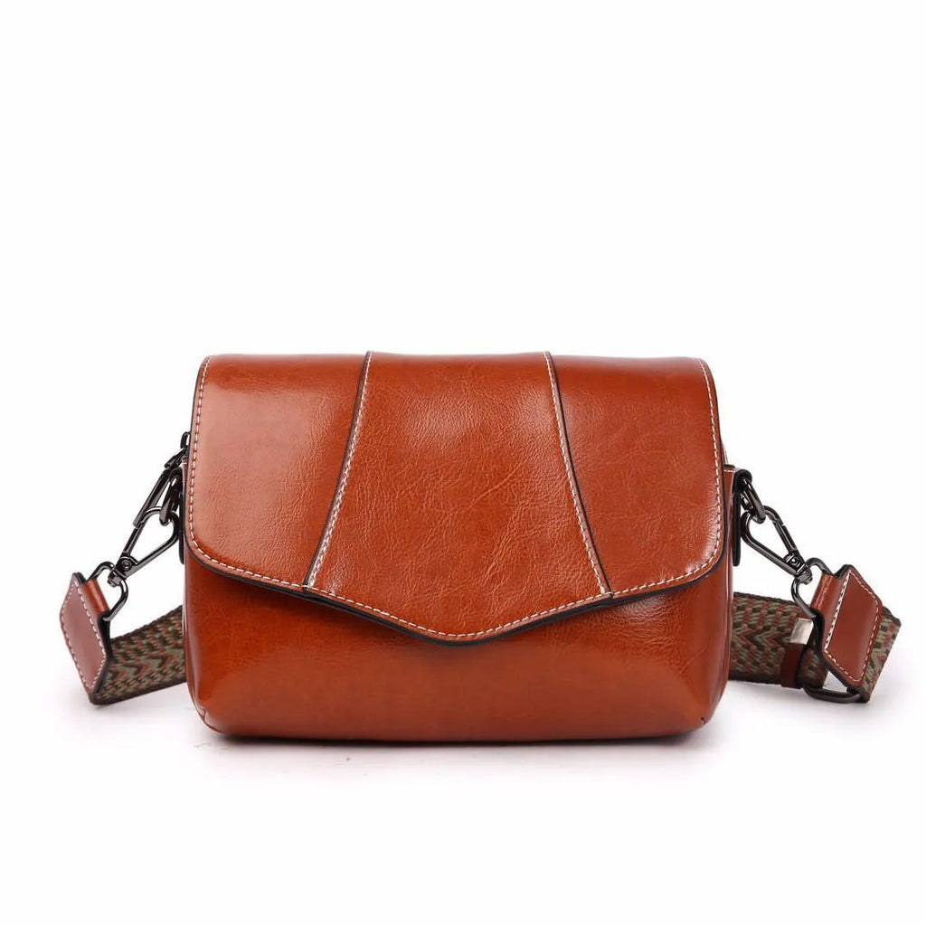 Top grain leather crossbody bag in caramel colour with zip closure and patchwork design