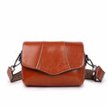 Top grain leather crossbody bag in caramel colour with zip closure and patchwork design
