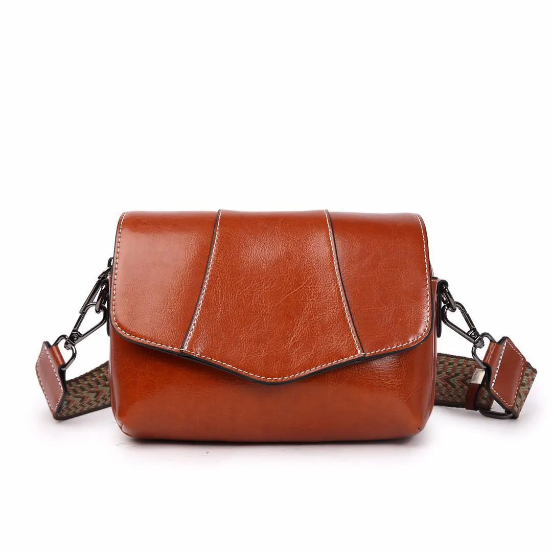 Top grain leather crossbody bag in caramel colour with zip closure and patchwork design