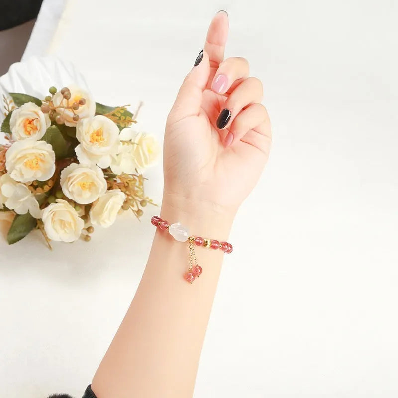 Handmade women's bracelet with natural strawberry quartz and agate 6mm round beads on a wrist.
