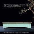 Handmade retro purple sand glaze ceramic bonsai flower pot in green colour on desktop