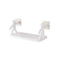 White plastic wall-mounted storage shelf in little man doll design on a bathroom wall