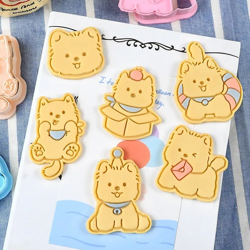 A 3D plastic biscuit mould showing raised puppy head, birthday hat, and dog cartoon designs.