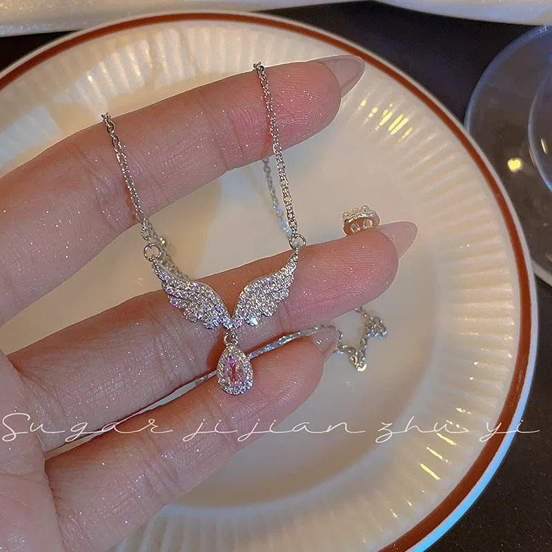 Women's sterling silver necklace showing Angel Wings and Fishtail pendant options on an adjustable O-ring chain.