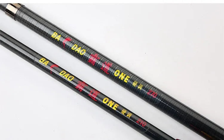 Carbon fibre telescopic spinning fishing rod with metal handle, extended, on a boat deck.