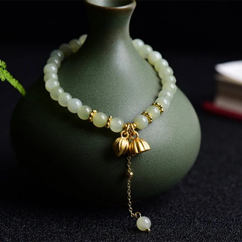 Natural Hetian Jade bracelet with six millimetre beads in step by step lotus pattern
