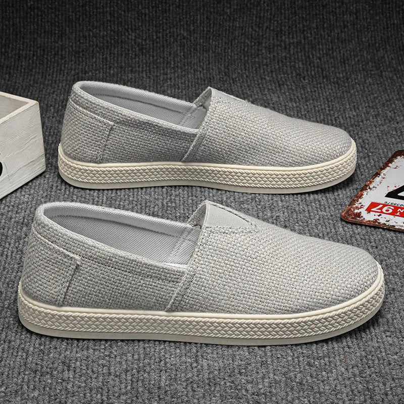 Men's beige linen cloth canvas shoes with round toe and visible stitching on PVC sole