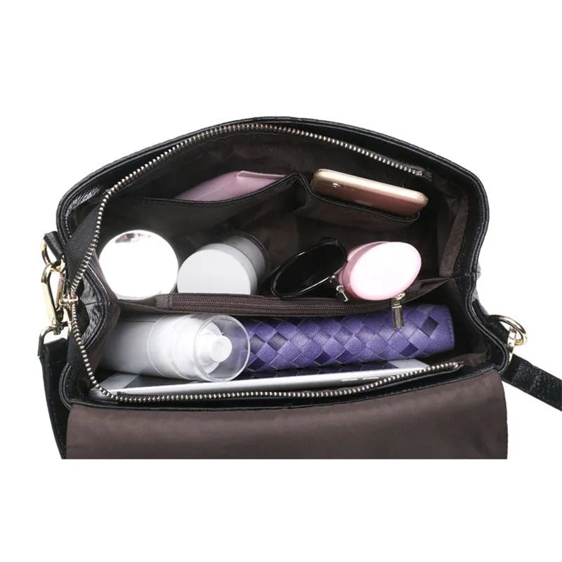 Genuine leather women's woven crossbody bag in black with embossed finish and soft handle