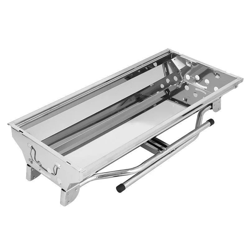 Large stainless steel folding portable barbecue oven with grill, shown outdoors.