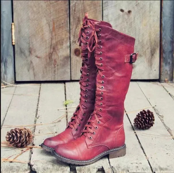 Black women's chunky heel high-leg boots with a round toe and short stout heel on a plain background.