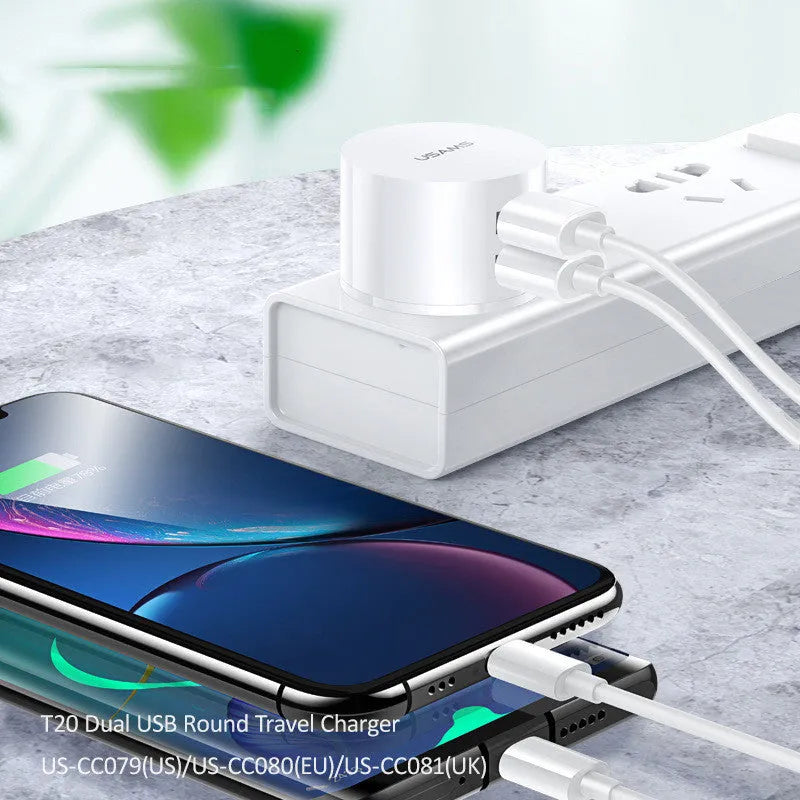 White portable universal dual USB phone charger showing US, EU and UK plug compatibility