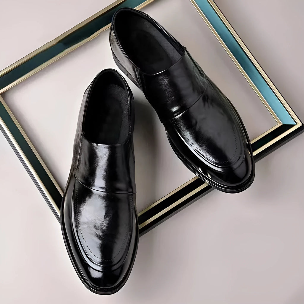 Men's black PU pointed toe slip-on formal shoes with rubber sole and metal detailing on a white background