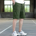Man wearing loose-fit khaki casual trousers, showing the Korean style and thin fabric texture.