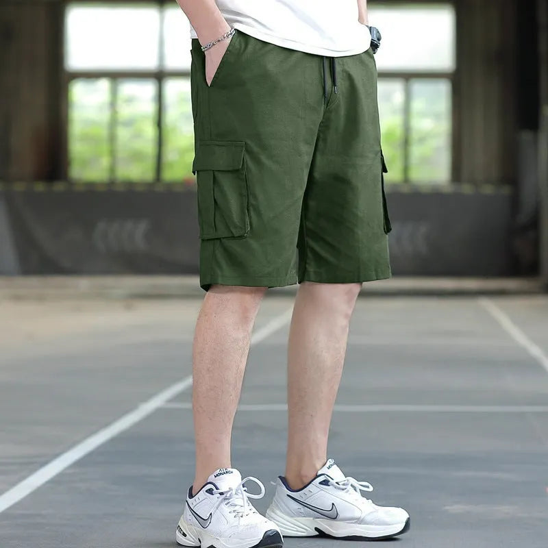 Man wearing loose-fit khaki casual trousers, showing the Korean style and thin fabric texture.