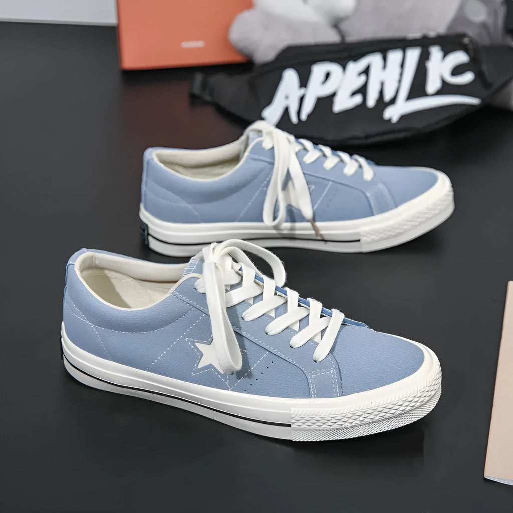 Low top board shoes with cross straps and leather stitching, available in green, black, light blue, grey, ink blue