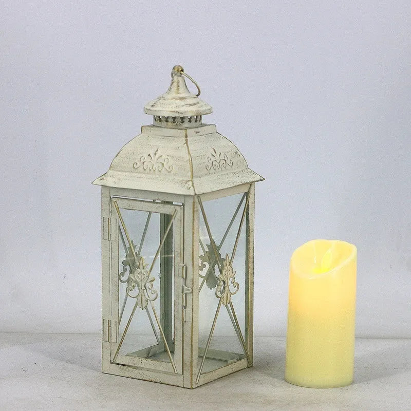European wrought iron storm lantern with tempered glass in black or white gold finish, shown in small, medium, and large sizes.
