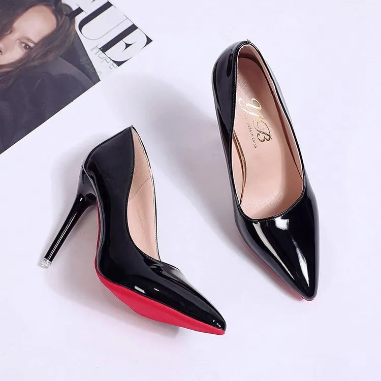 Women's black stiletto heel pump with pointed toe and shallow mouth opening on a white background.