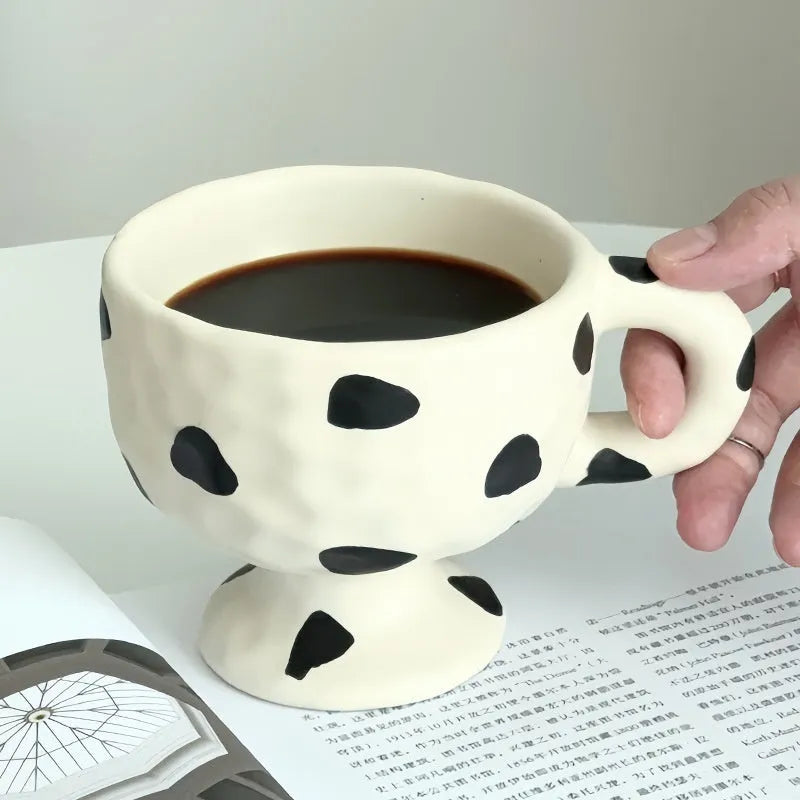 Hand-pinched irregular ceramic mug showing solid colour and unique shape
