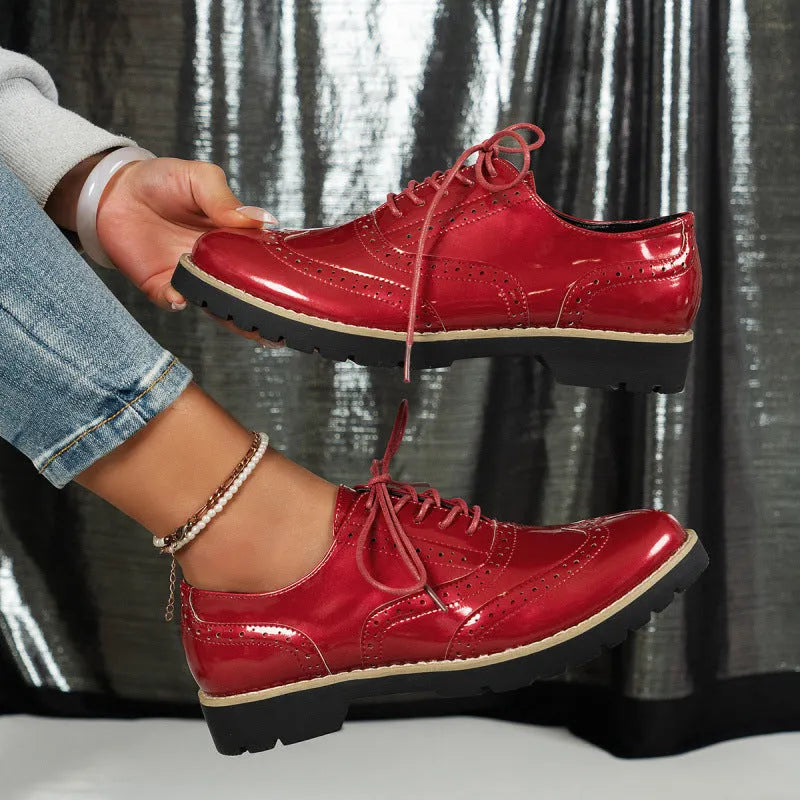 Women's black oxford shoes with wedge heel and sequin detailing, showing round toe and middle mouth cut