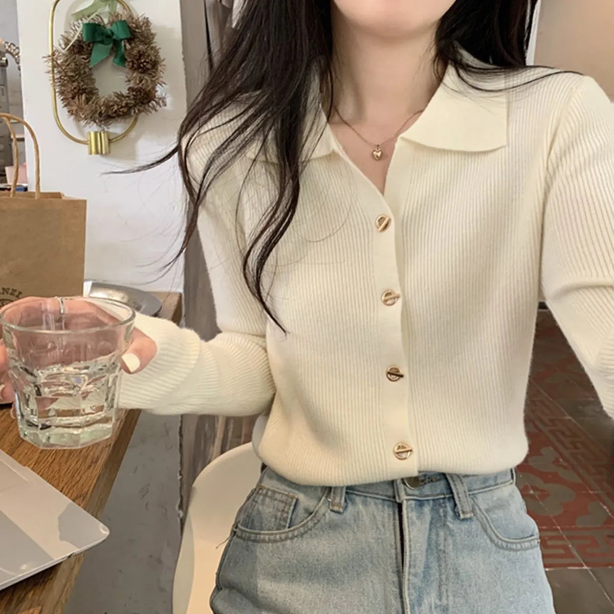 Loose fit long sleeve viscose knitted cardigan in beige, shown worn open.
